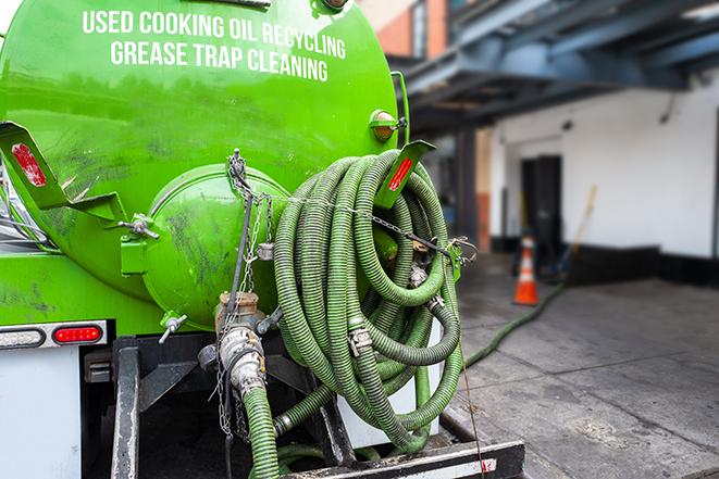 maintenance crew pumping grease trap at a fast food restaurant in Donna, TX